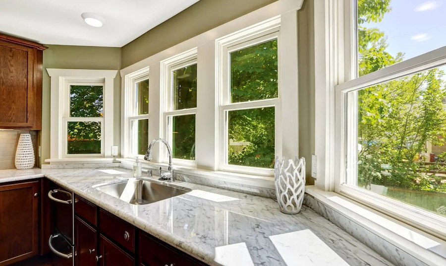 Inside the kitchen of a Charlotte home looking outside through brand new replacement windows.