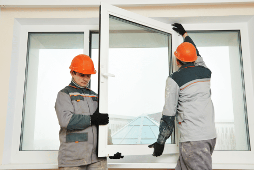 two professionals replacing a window in ahome