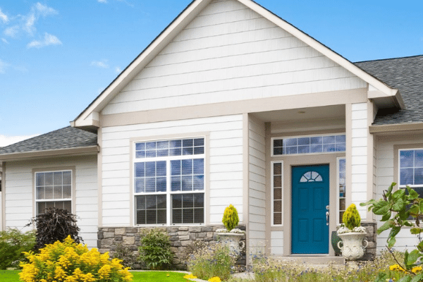 Home exterior with blue front door and large picture replacement window