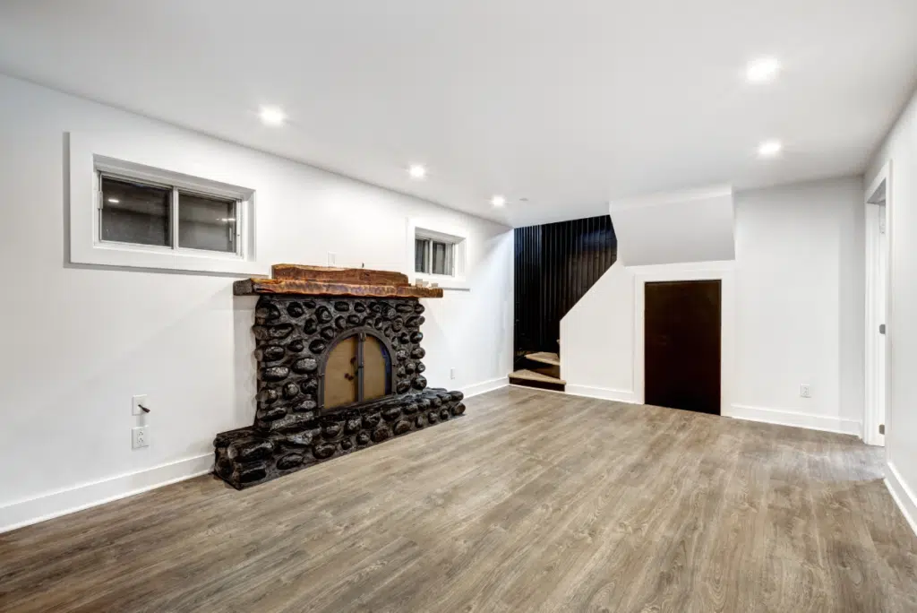 basement with a fireplace and small windows