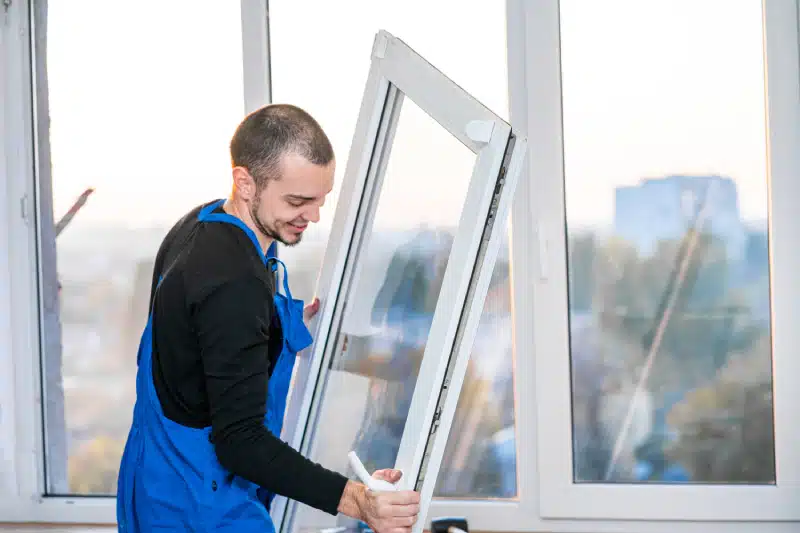 man removing a window from the frame