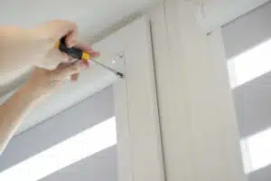 Man installs window casing in a home